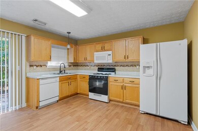 Kitchen featuring pendant lighting, sink, light ha