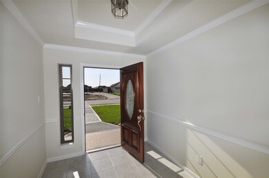 Elegant Foyer features a beautiful triple pane mahogany front door.