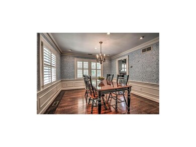 Spacious dining room with wainscoting, and inlay w
