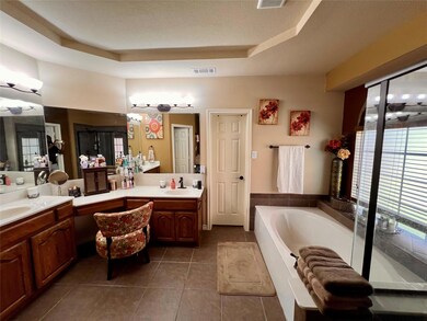 Bathroom featuring visible vents, vanity, a bath, 