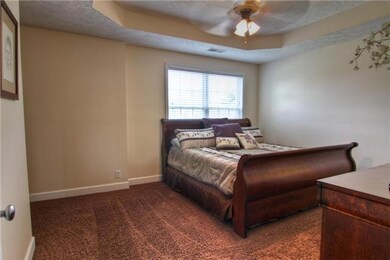 Master bedroom is spacious and has tray ceiling.