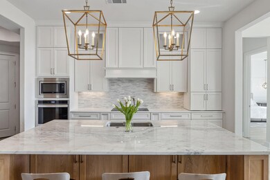 Kitchen with tasteful backsplash, visible vents, s