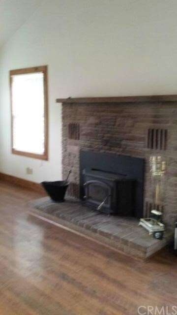 Wood burning stove insert in main house