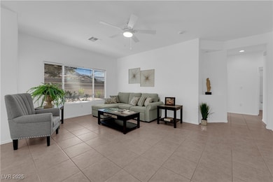 Living area with light tile patterned floors, a ce
