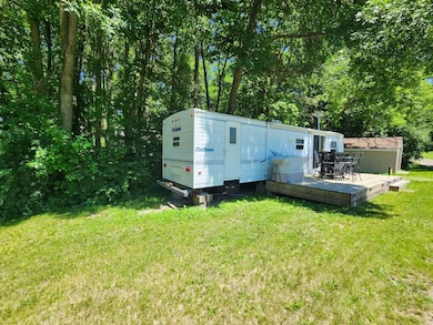 2000 38' Bunkhouse backs up to trees and a little creek and includes comforts for larger family and a shed and deck.jpg