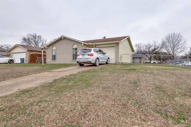 View of front of house with a garage and a front y
