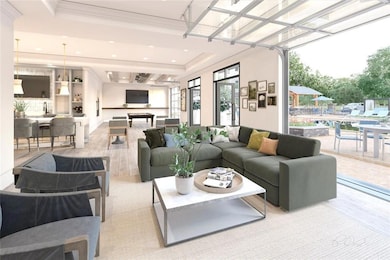 Living room with ornamental molding, light hardwood / wood-style floors, and sink