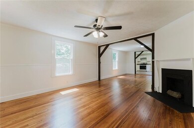 Unfurnished living room featuring hardwood / wood-