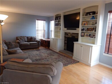 Family room with built in shelves and gas fireplac