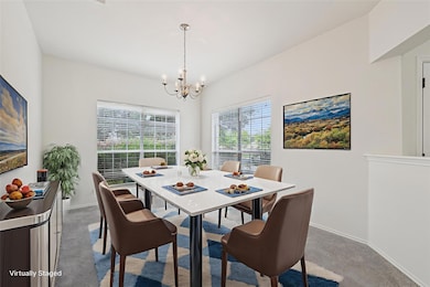 Dining space with a chandelier, carpet floors, an