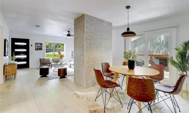 Dining area with light wood-style floors and a ceiling fan