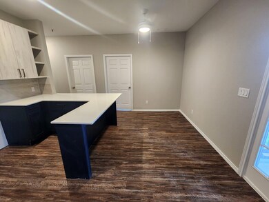 Kitchen featuring light countertops, a peninsula,