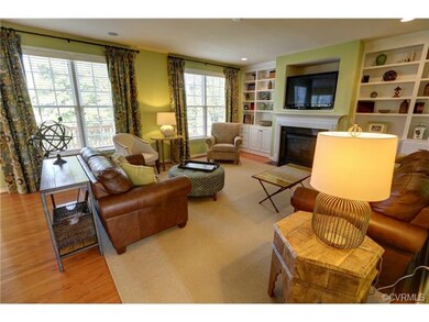 Gorgeous family room features hardwood floors, bui