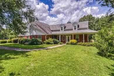 View of front of home with a front yard and a porch