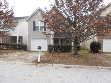 View of front of property featuring a garage and d