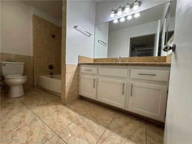 Full bath with toilet, vanity, wainscoting, bathtu