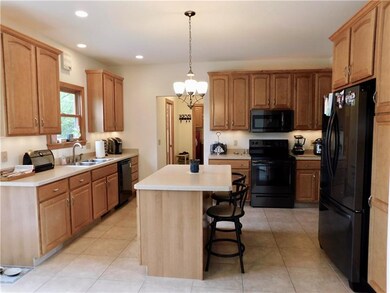 Open concept kitchen with maple cabinets, new blac