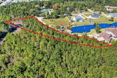 Aerial view of property and surrounding area featuring property parcel outlined