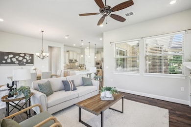 Living room featuring baseboards, ceiling fan, da