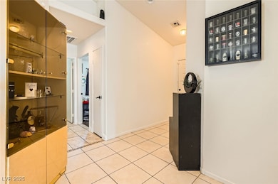 Hallway with tile patterned floors, visible vents,