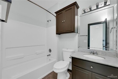 Full bath with toilet, vanity, and shower / washtub combination