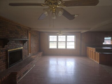 Unfurnished living room featuring hardwood / wood-