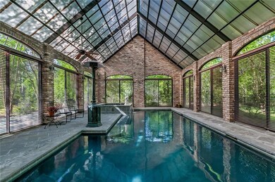 Enclosed heated pool.  Hydro-tub and fountain.  Sw