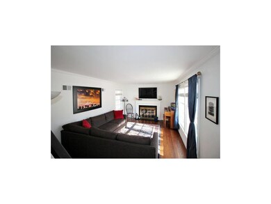 Living room features large windows with fireplace.