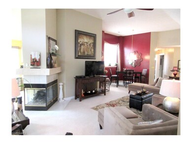 Open living room with three-sided gas fireplace