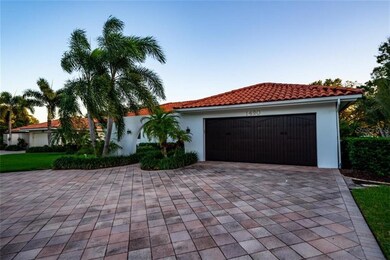 The paved  driveway compliments the tile roof.