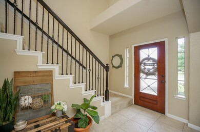 Neutral ceramic tile floor foyer entry with soft n