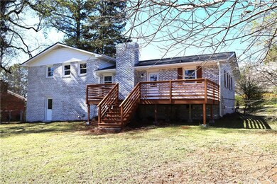 Back of property featuring brick siding, stairway,