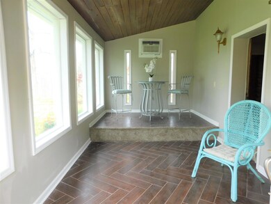 Another picture of the Foyer showing large windows to enjoy nature in your front yard.