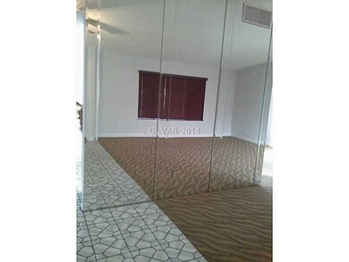 Property Photo. Mirrored Living Room Wall