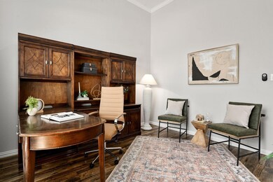 Home office with crown molding and dark wood-type flooring