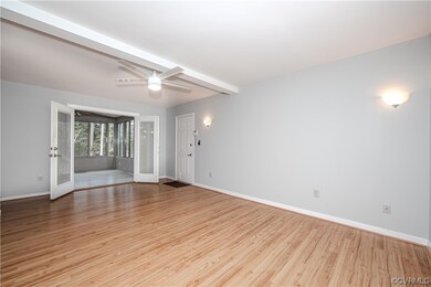 Sunroom off family room with light hardwood / wood