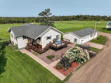 Exterior space with a deck, a front lawn, and a ru