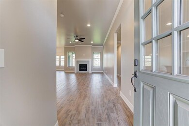 Foyer entrance with a ceiling fan, crown molding, 