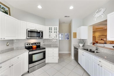 Updated kitchen with quartz counters, new sink, and new cabinets. Stainless appliances set off its beauty. Also, kitchen clean-up is never boring with your pass-through views to TV, living, dining room, lanai and lake-views!
