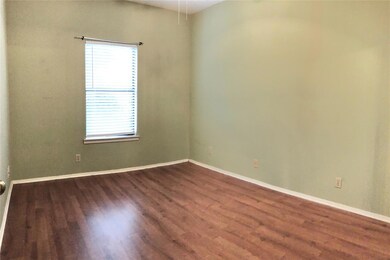Spare room featuring baseboards and dark wood-sty