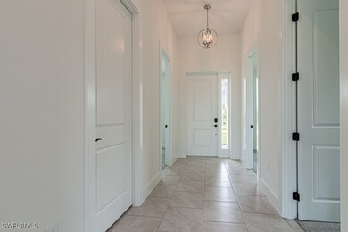 Entrance foyer featuring a chandelier and light ti