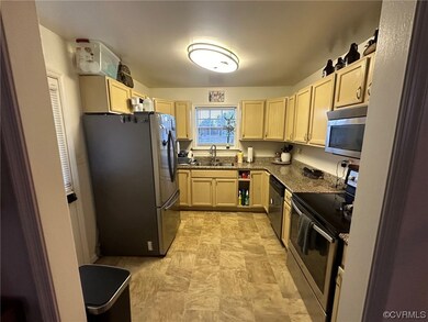 Kitchen featuring light brown cabinets, sink, ligh