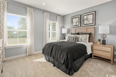 Bedroom with light carpet and baseboards