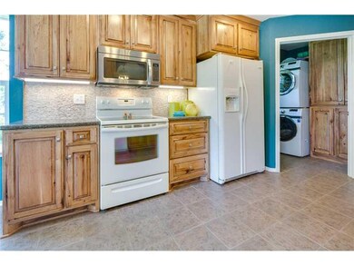 Kitchen. MAJOR recent kitchen remodel with solid surface countertops and stunning hickory cabinets.