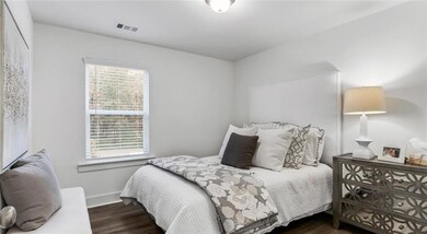 Bedroom with wood finished floors and baseboards