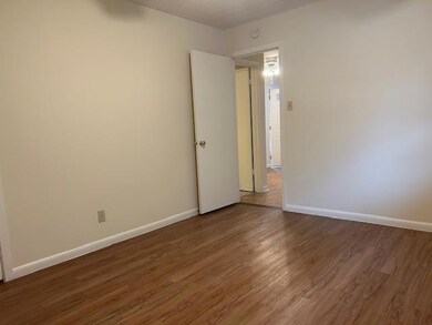 Empty room with baseboards, wood finished floors,