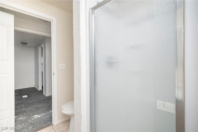 Full bathroom featuring a shower stall and tile pa