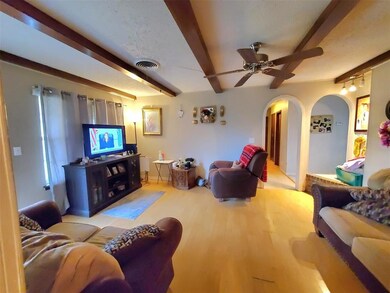 Living area with visible vents, wood finished floo