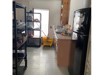 Kitchen featuring black fridge