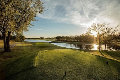 View of home's community with a water view, a lawn, and golf course view